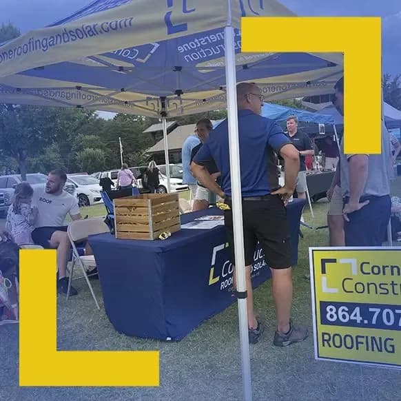 Cornerstone Construction employees table at a community event.