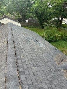 Worn, aging gray asphalt shingle roofing.