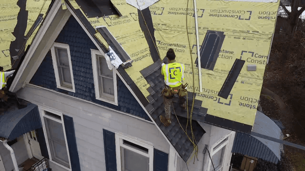 A worker installs new roofing on a home.