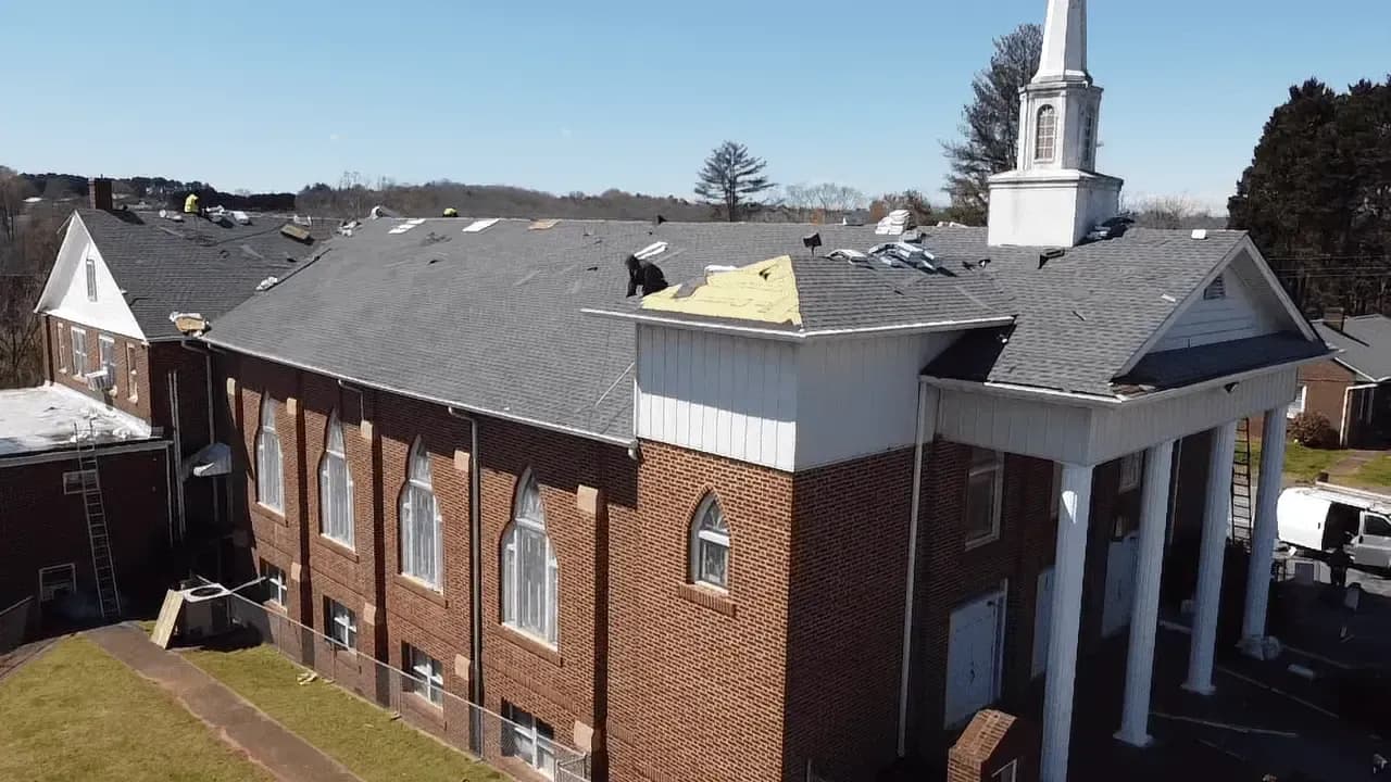 A new roof is installed by Cornerstone Construction on a church.