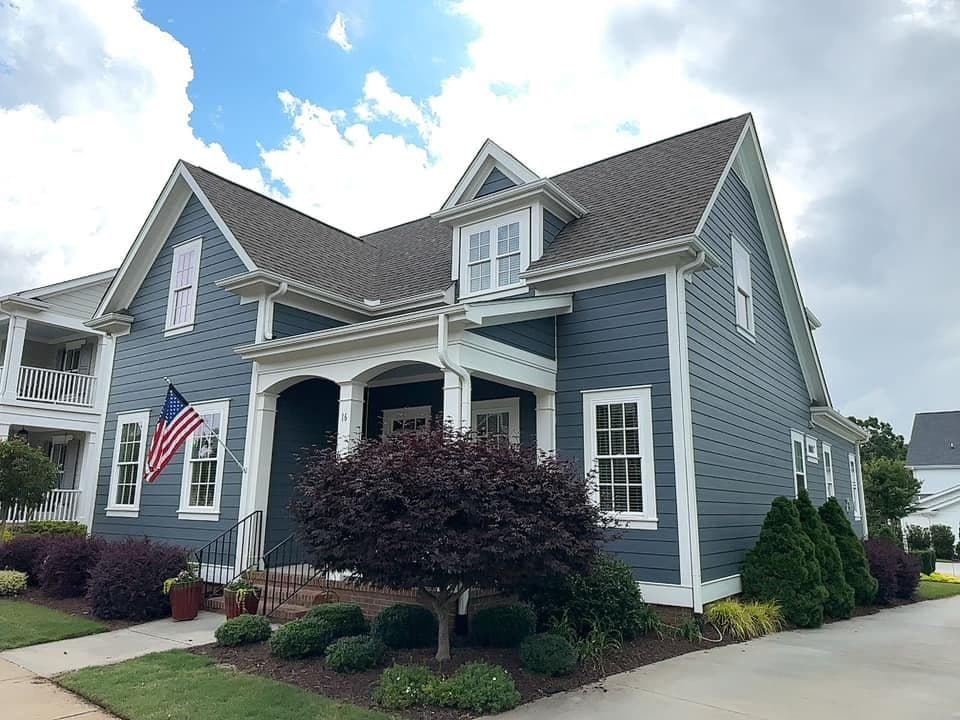 A house with new blue gray siding and white trim.